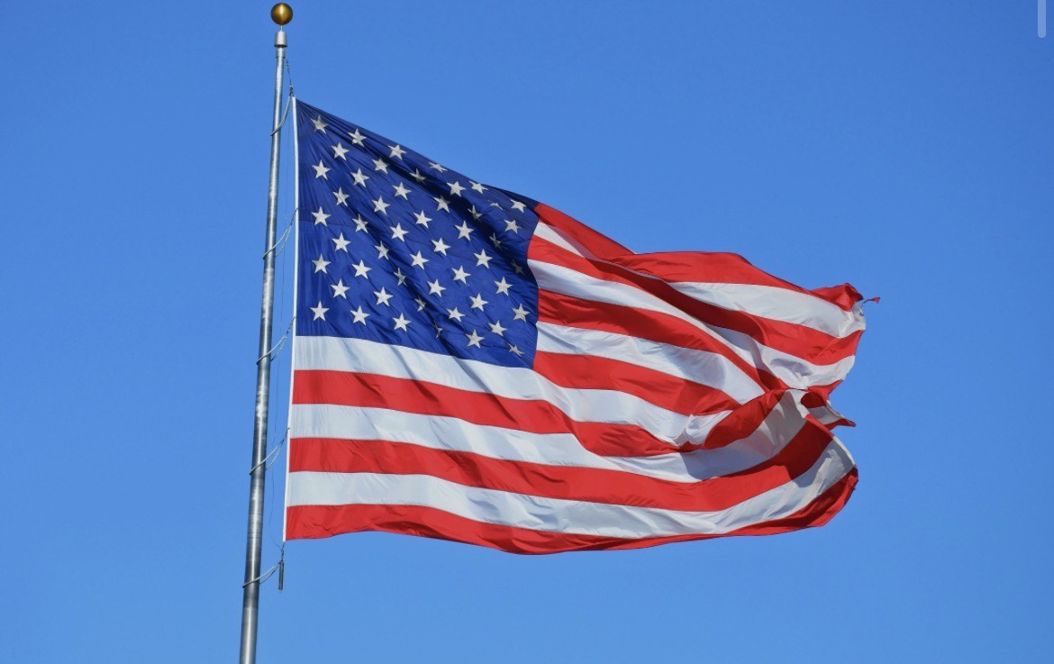 A picture of the United States of America's flag hoisted high